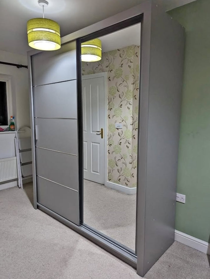 Sliding wardrobe with mirror door in a room.